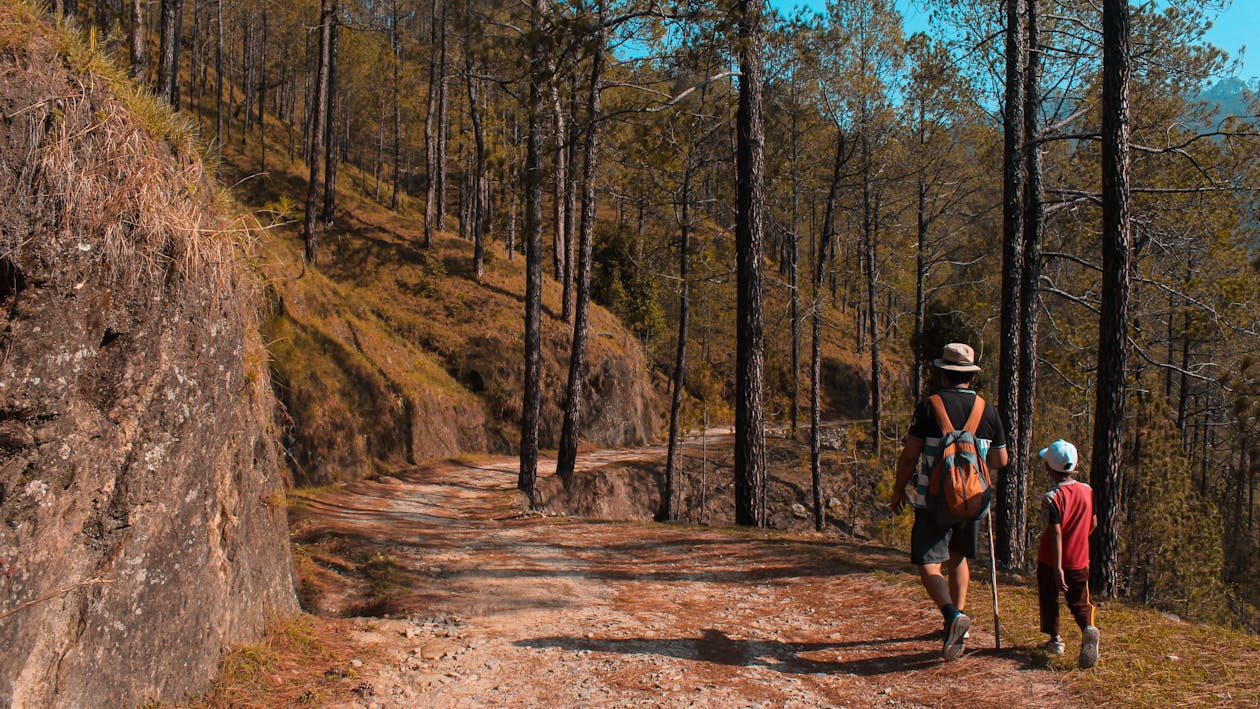 Free Man and Kid Walking on Downhill Stock Photo