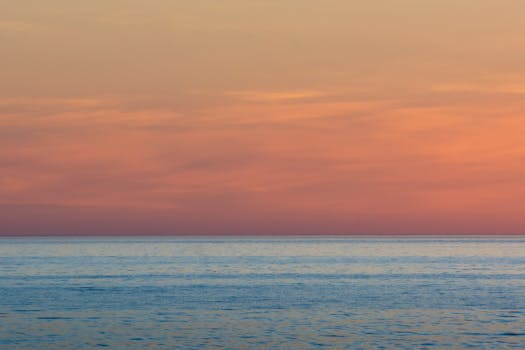 A calming ocean scene with a vibrant sunset sky, offering a sense of tranquility and peace.