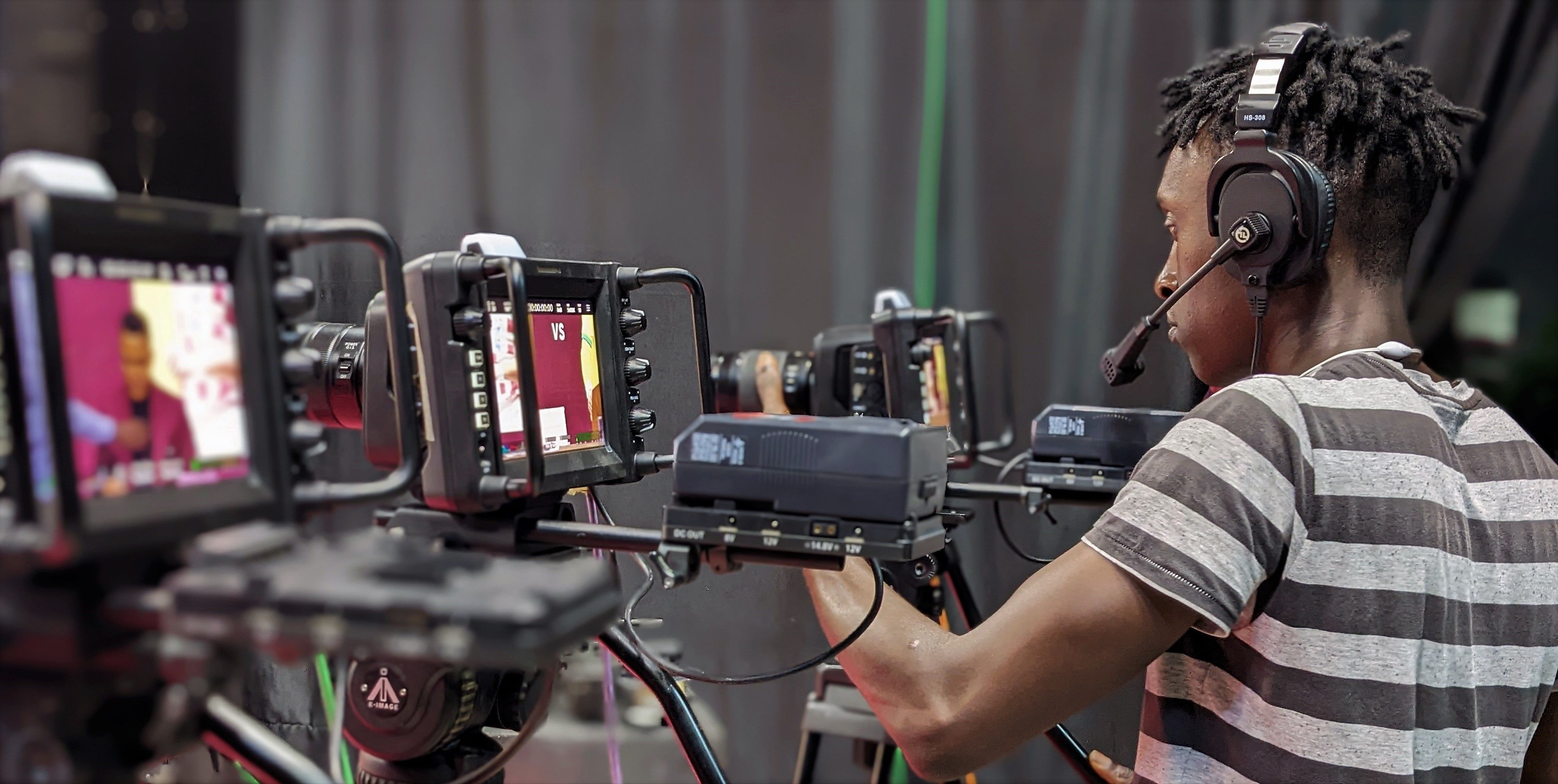 A person operating multiple video cameras