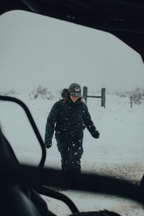 Woman in Black Jacket Walking Outdoors During Winter