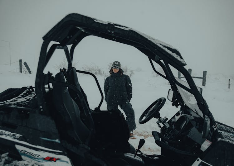 Woman Standing At A Buggy Car In Winter