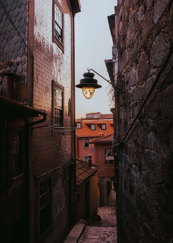 Tiled alley in the old town of Porto at golden hour — photo by Artūras Kokorevas on Pexels