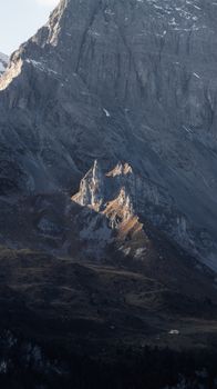 A stunning view of rugged mountain peaks with sunlight casting dramatic shadows.
