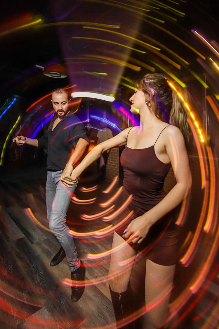 Couple Dancing In Club Under Moving Strobe Light