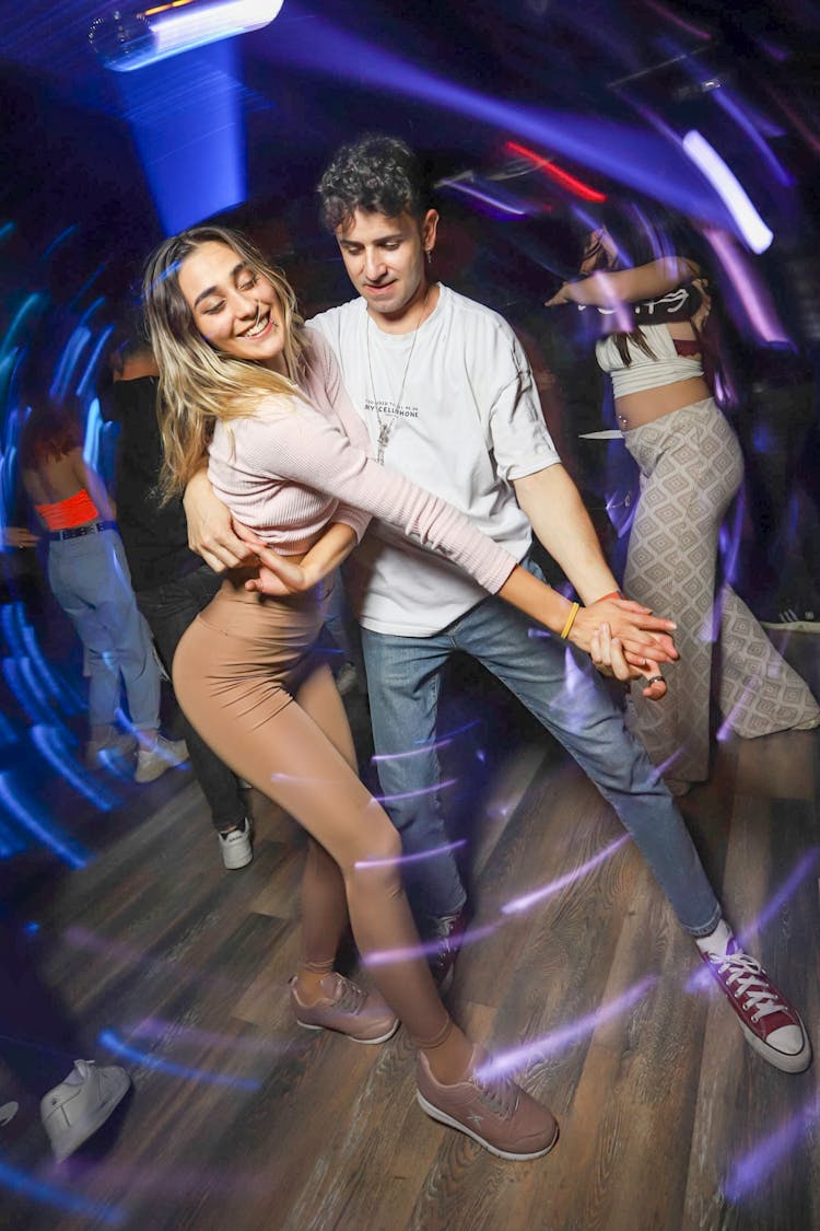 Couple Dancing In Club Under Blue Light