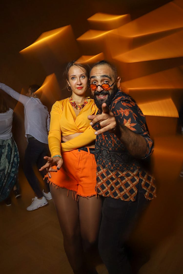 Couple Dressed In Colorful Clothes In Club