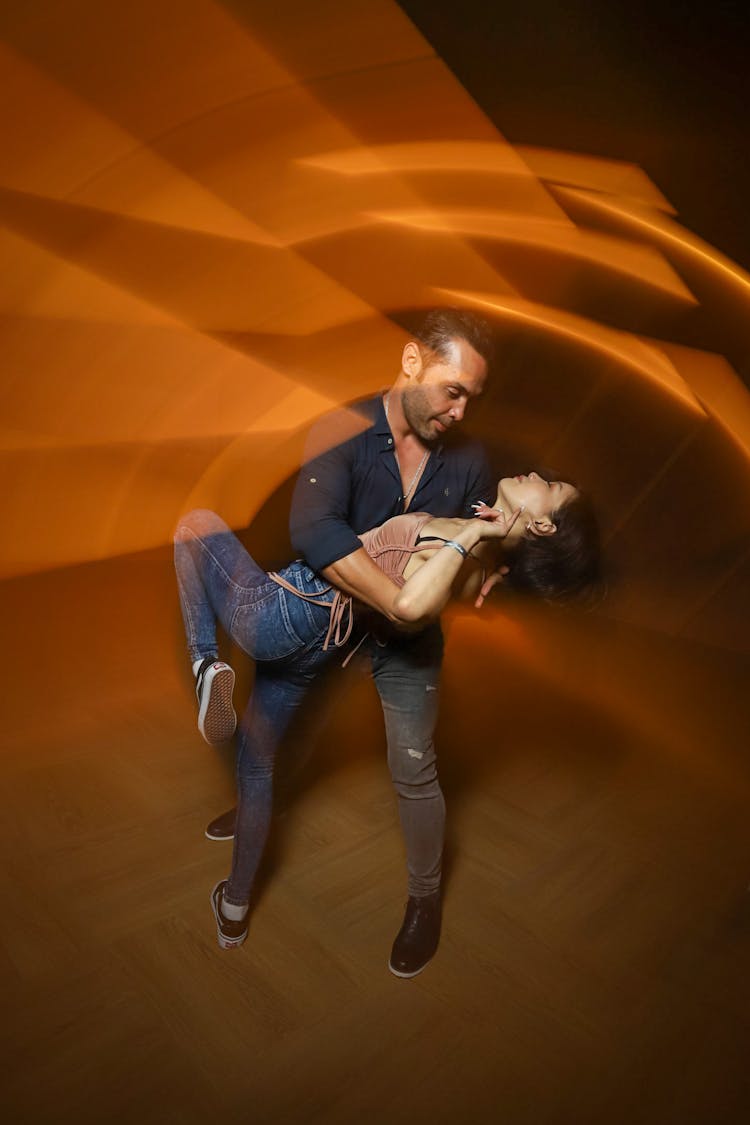 Couple Dancing Under Orange Light