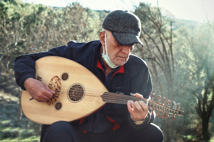 An Elderly Man Playing Oud