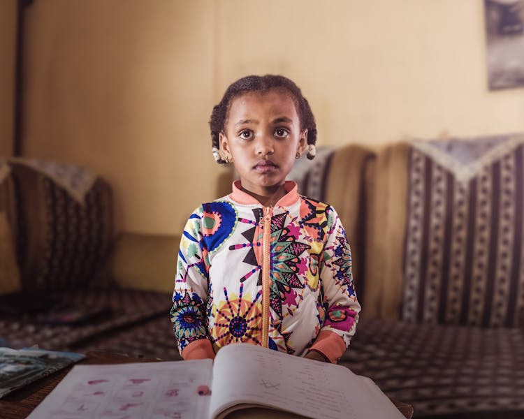 Cute Girl With Book At Home