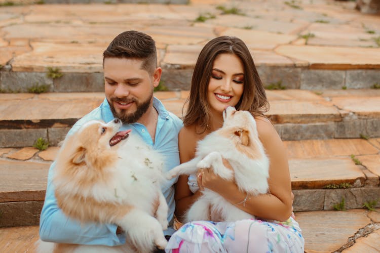 Man And A Woman With Their Pet Dogs