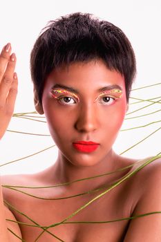 Vibrant portrait featuring a woman with colorful eye makeup and bold red lipstick.