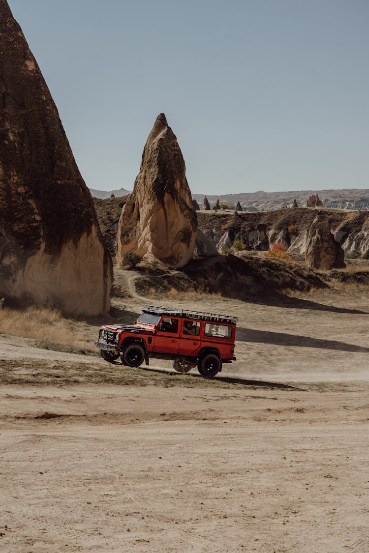 Car On Desert Between Rocks