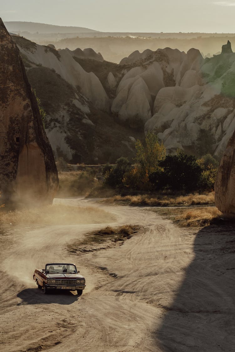 Car On Desert Between Rocks