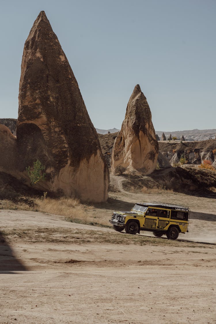 Car On Desert Between Rocks