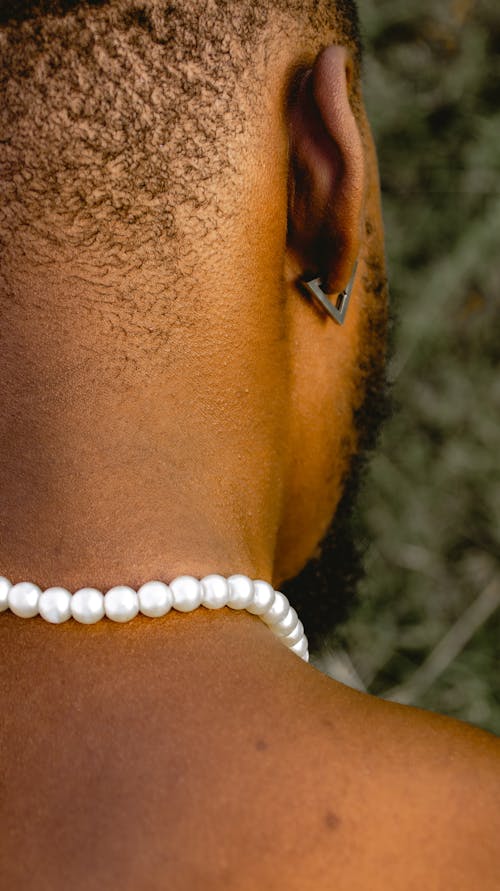 A Man Wearing Pearl Necklace