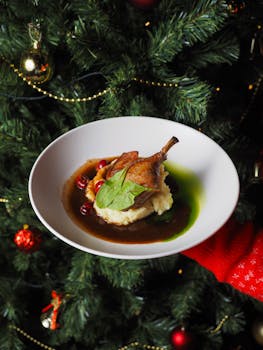 Delicious gourmet duck dish served in front of a festive Christmas tree, perfect for holiday dining.
