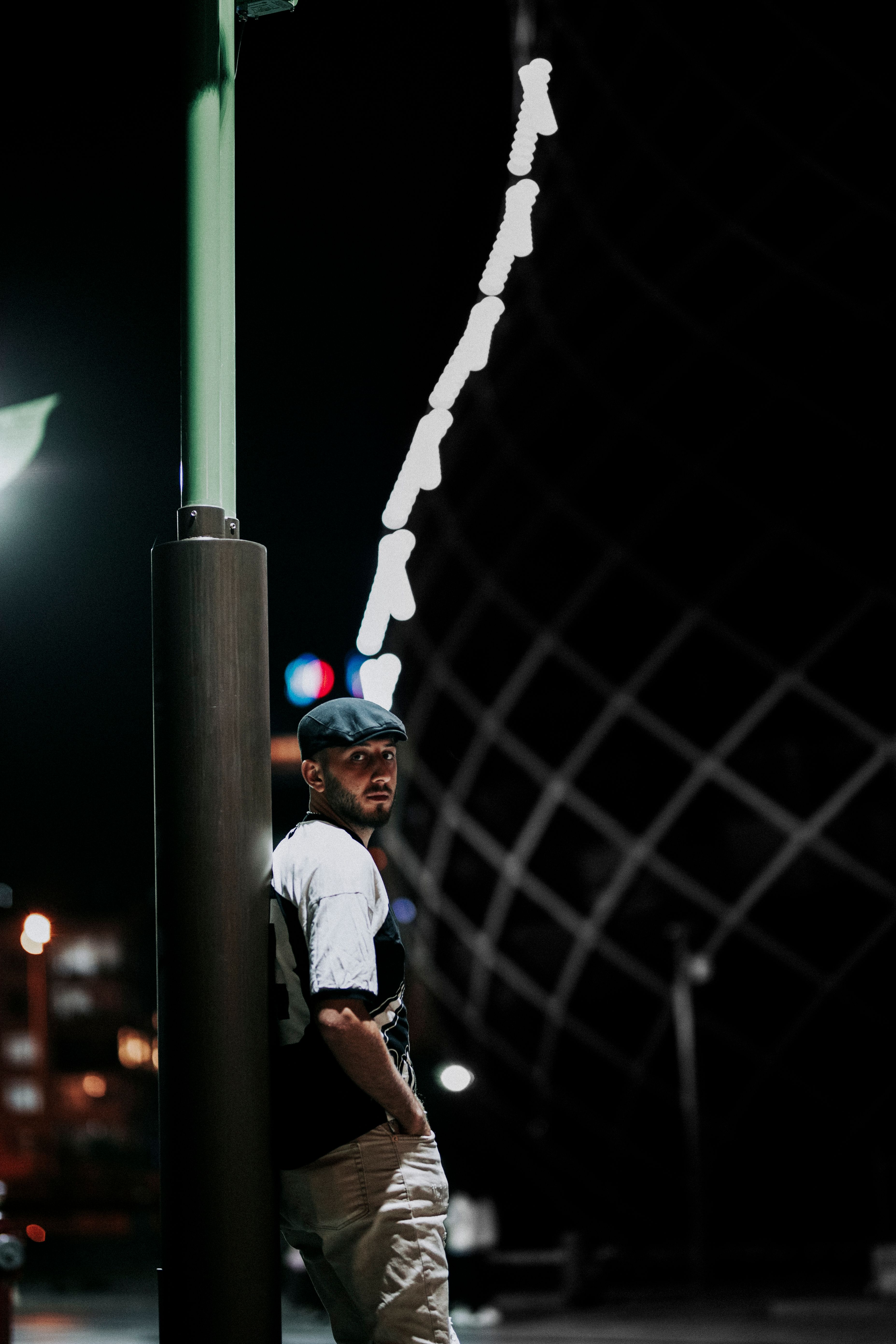 Man in Cap Posing on Night Street · Free Stock Photo