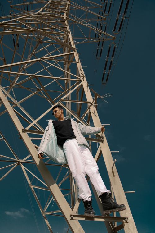 A man standing on top of a power tower · Free Stock Photo