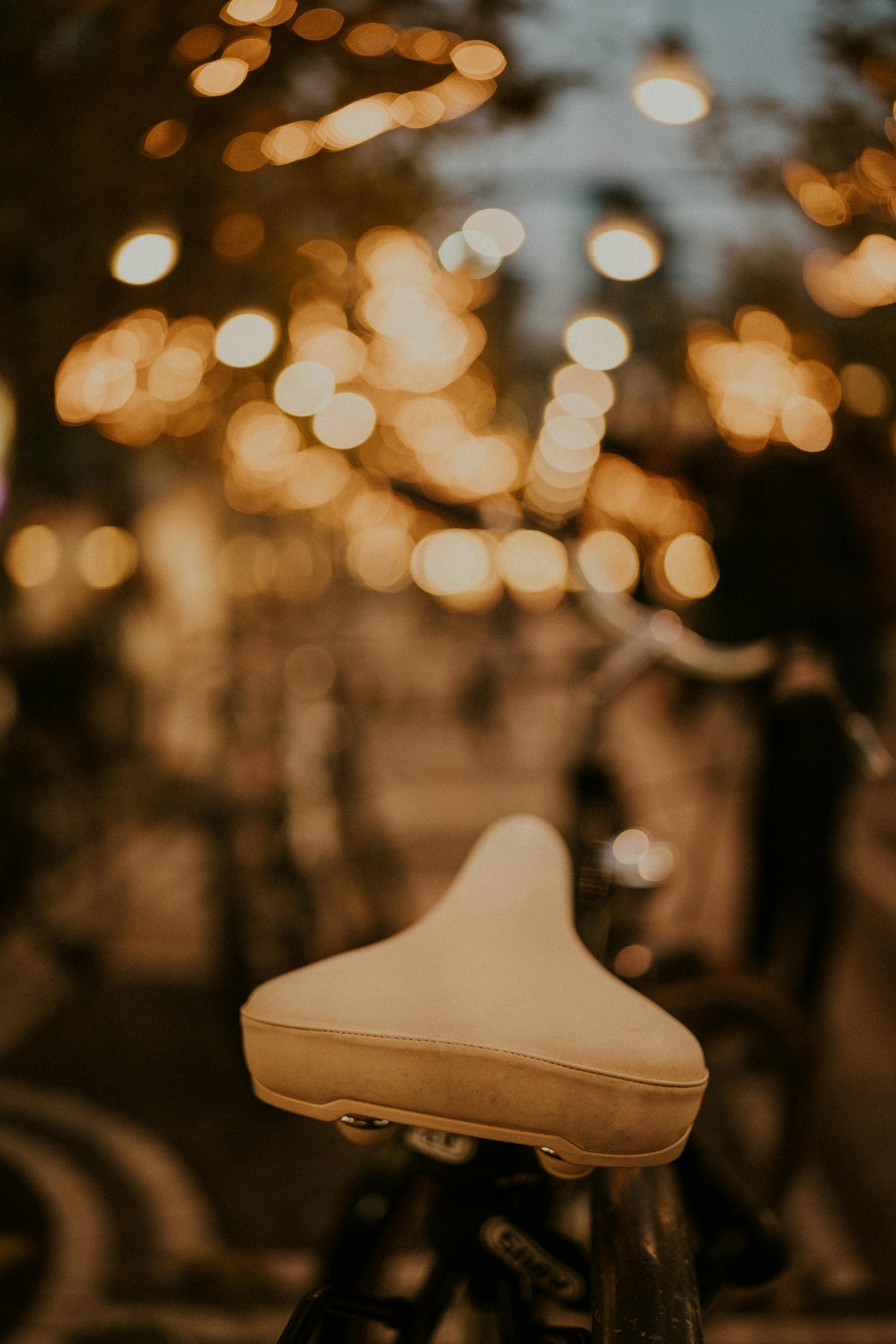 Bicycle Saddle on the Background of Warm Blurry Lights · Free Stock Photo