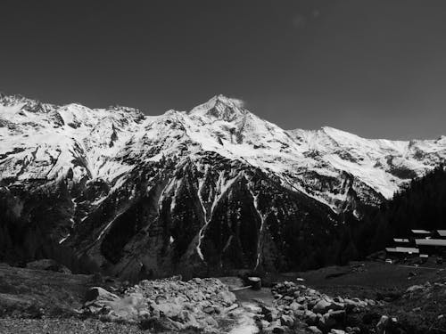 Grayscale Photo of Snow-Covered Mountains