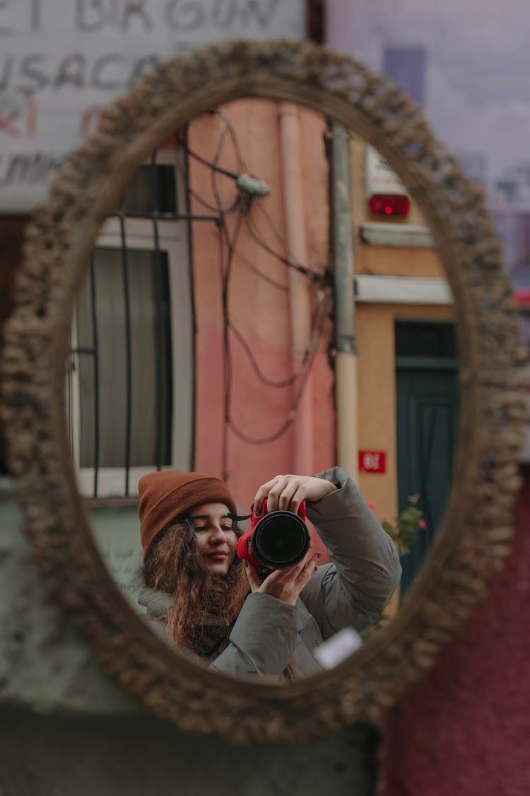 Woman Taking Mirror Selfie On City Street