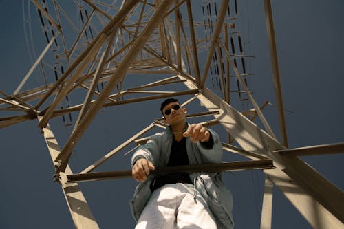 A Man Climbing a Steel Tower