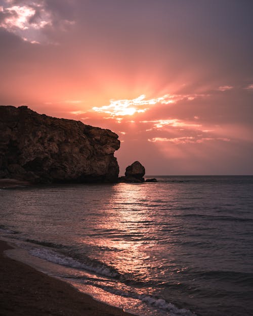 Brown Rock Formation on Sea during Sunset