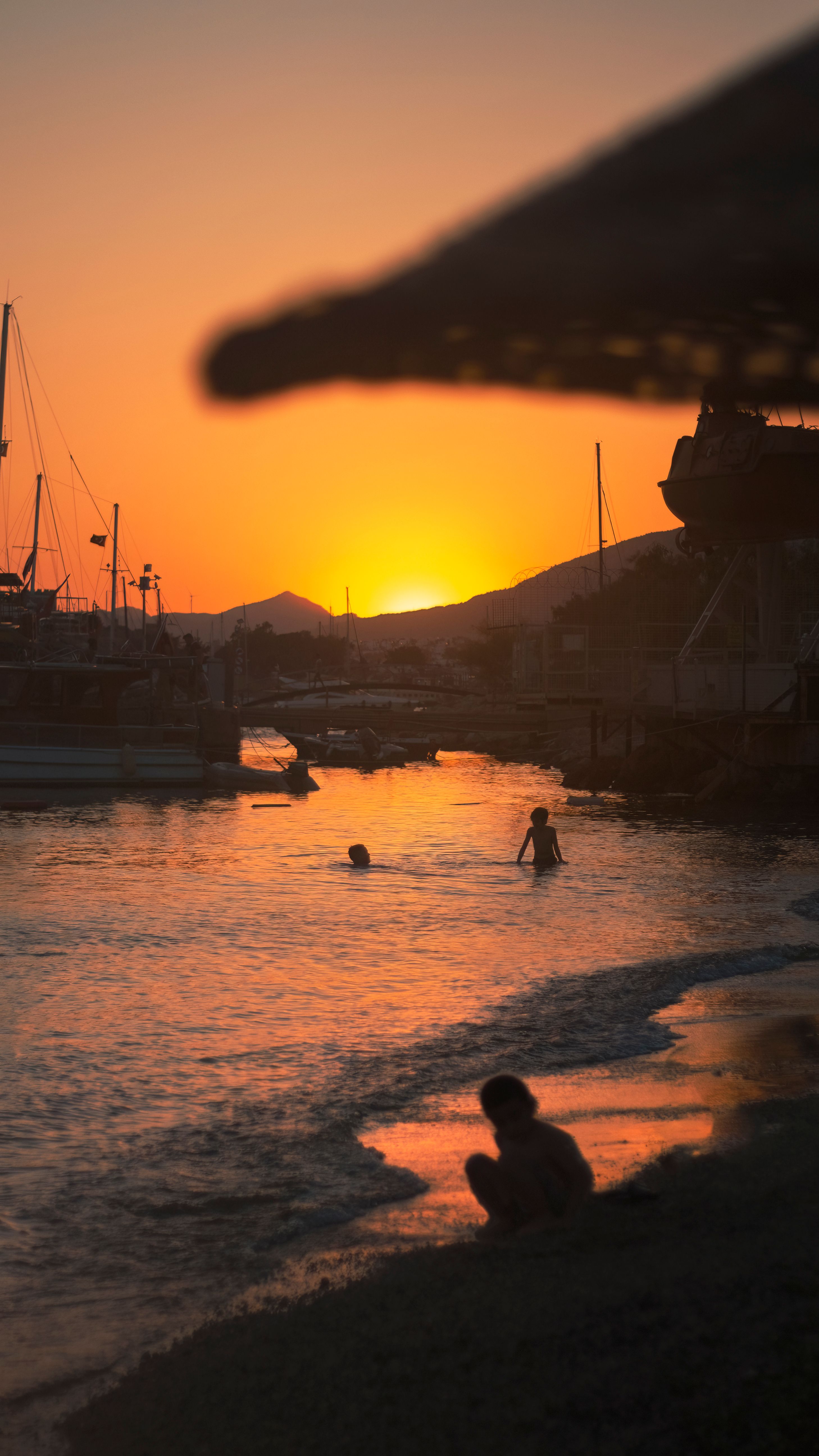 Silhouette of People Bathing in the Sea at Sunset · Free Stock Photo