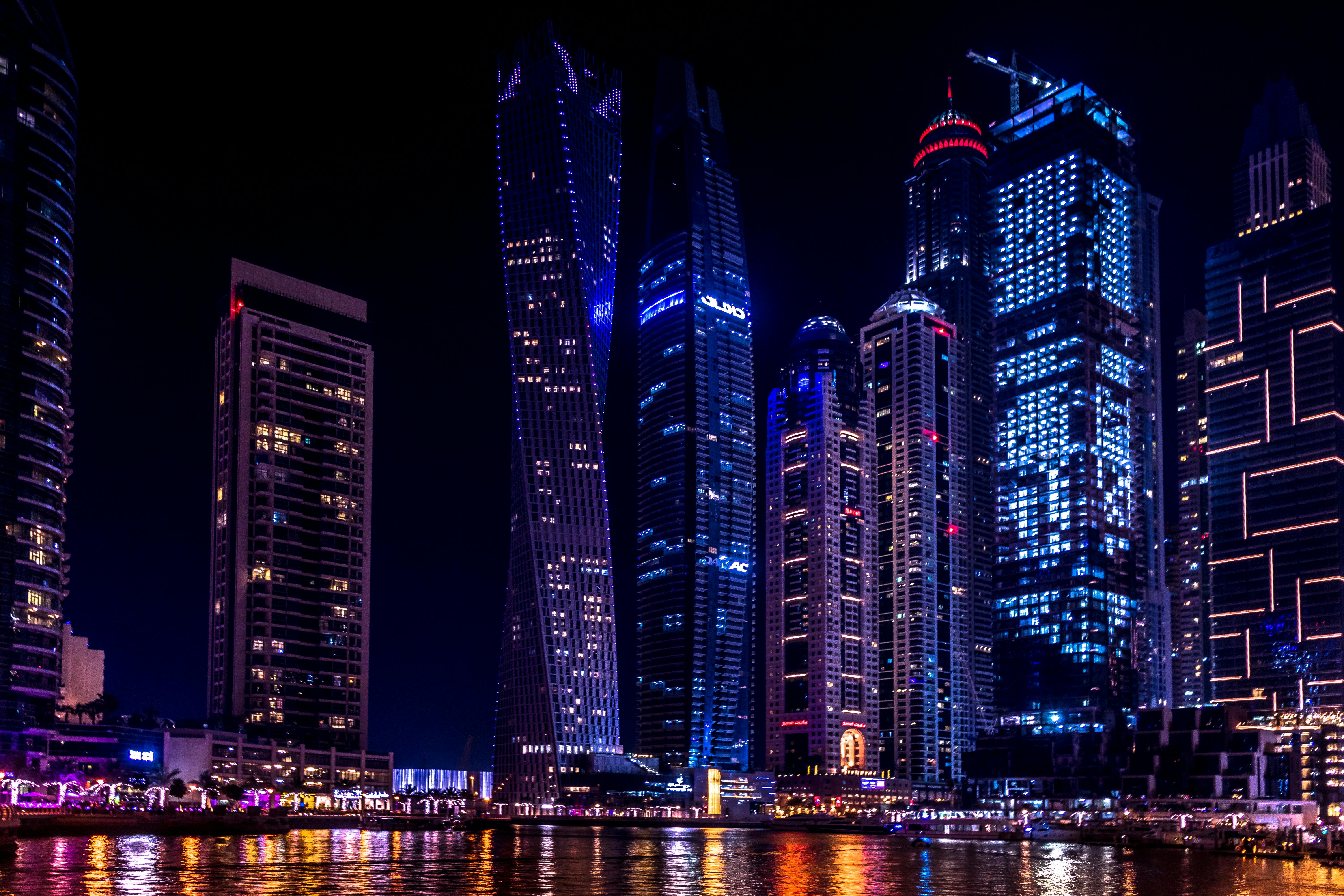 Body of Water Near Lighted Buildings at Night \u00b7 Free Stock Photo