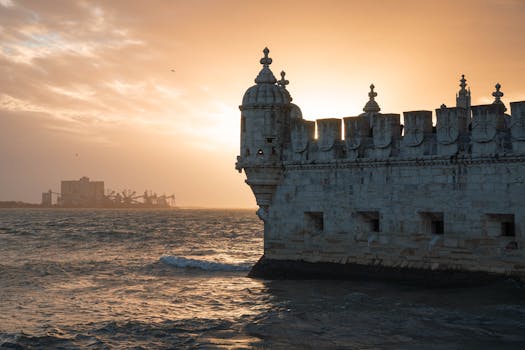 Belem Tower overlooking the sea at sunset in Lisbon, Portugal. A dramatic view of this iconic landmark.