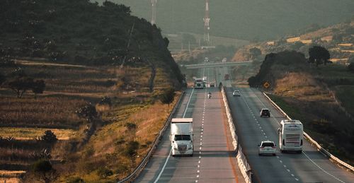 Free A bustling highway scene showcasing various vehicles traveling through a picturesque landscape. Stock Photo