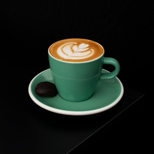 A Cortado Drink with Latte Art on Green Ceramic Cup