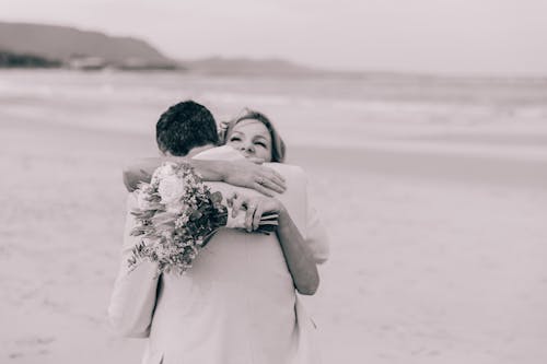 A Couple Embracing Each Other at a Beach