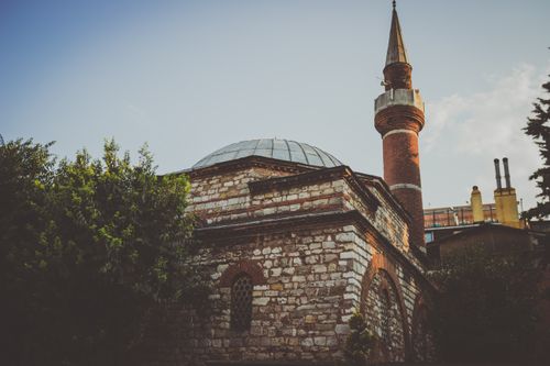 Free Atmospheric view of an ancient stone mosque with a minaret in Istanbul, Turkey. Stock Photo