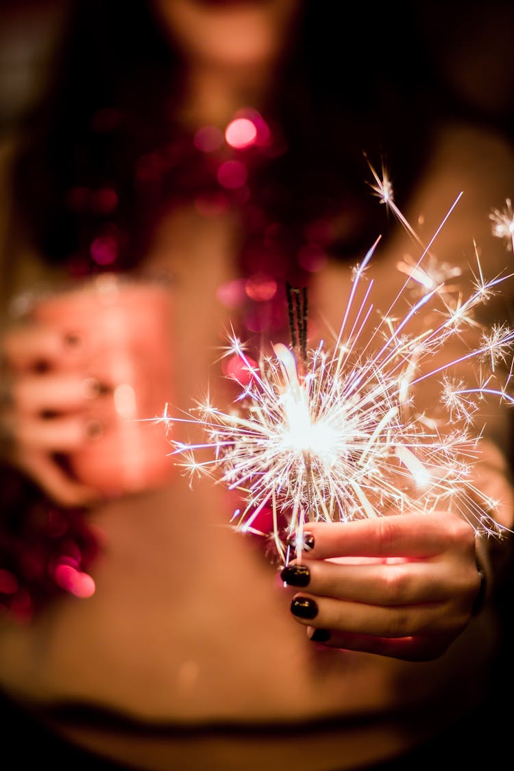 Woman Holding Burning Sparkler