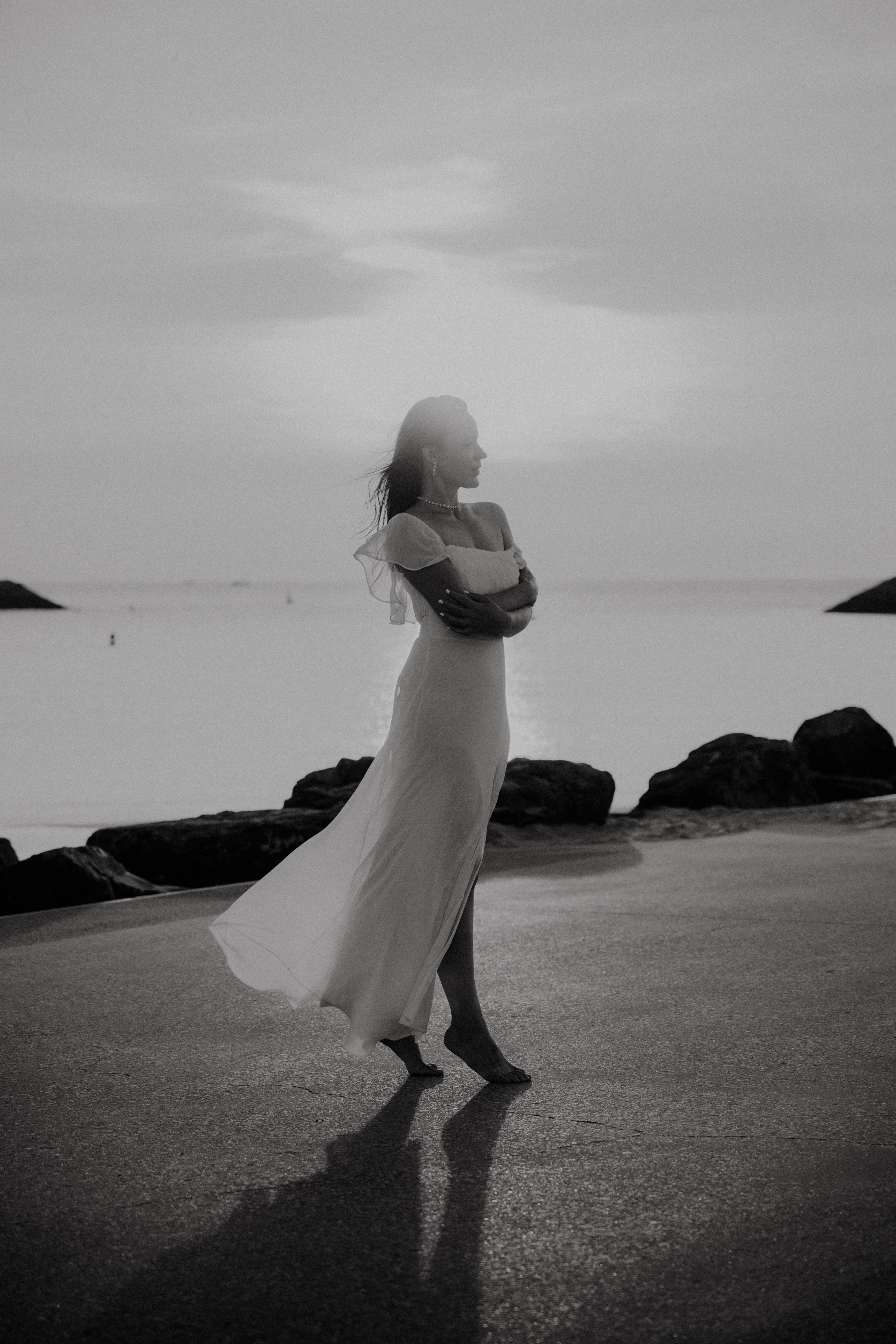 Woman in a White Dress Barefoot on the Seashore · Free Stock Photo