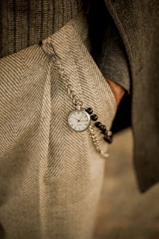A classic pocket watch in vintage menswear, capturing elegance and timeless style.