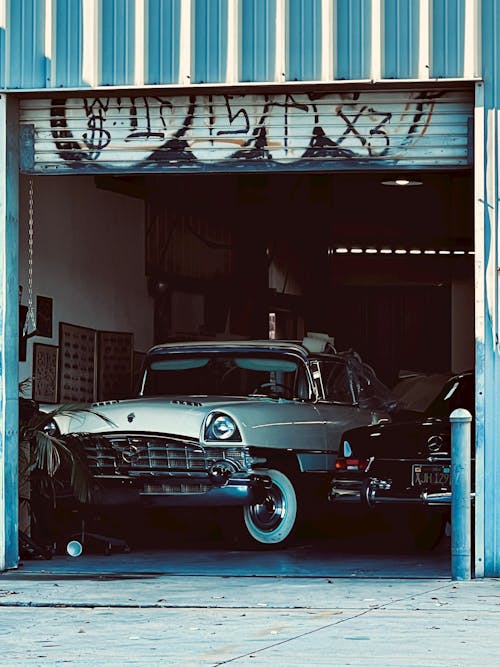 White Vintage Car Parked on Garage
