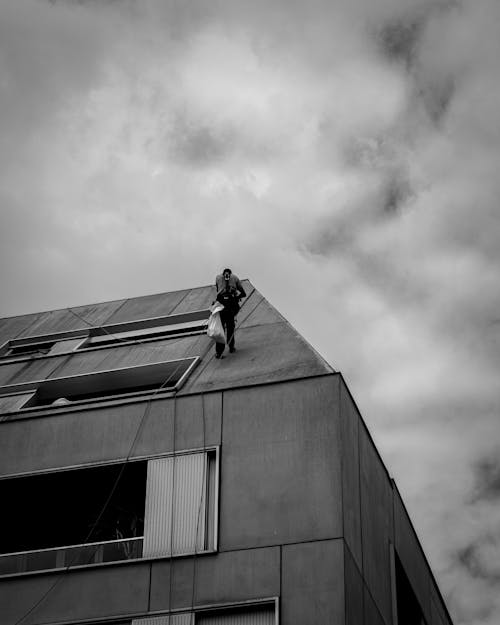 Person with Bag Standing on Building Roof