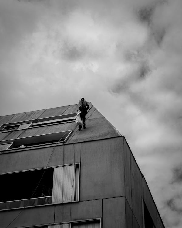 Person with Bag Standing on Building Roof