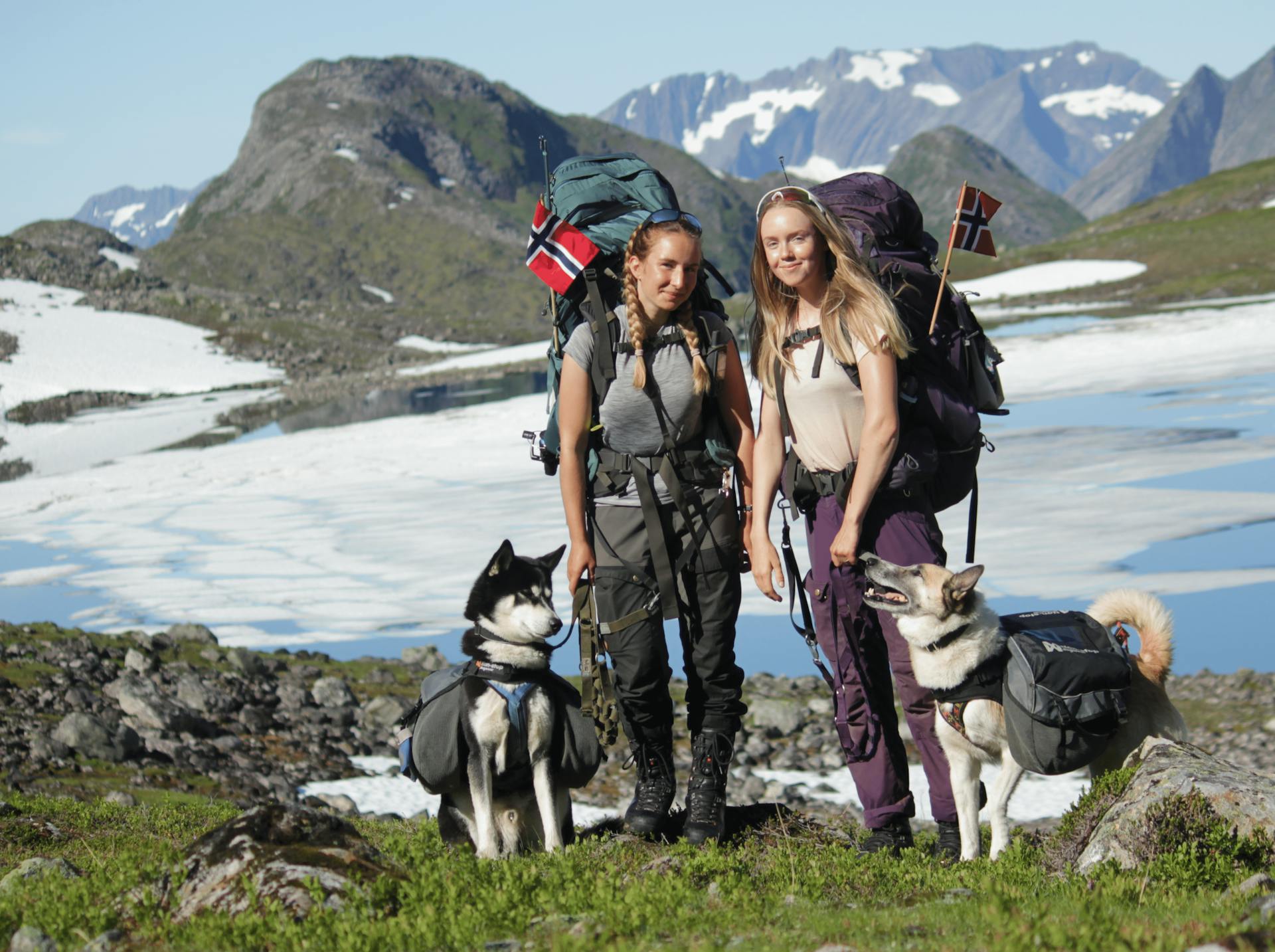 Photo of Two Women with Dogs while Backpacking in the Mountains