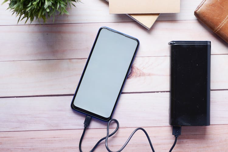 A Smartphone Charging With A Power Bank 