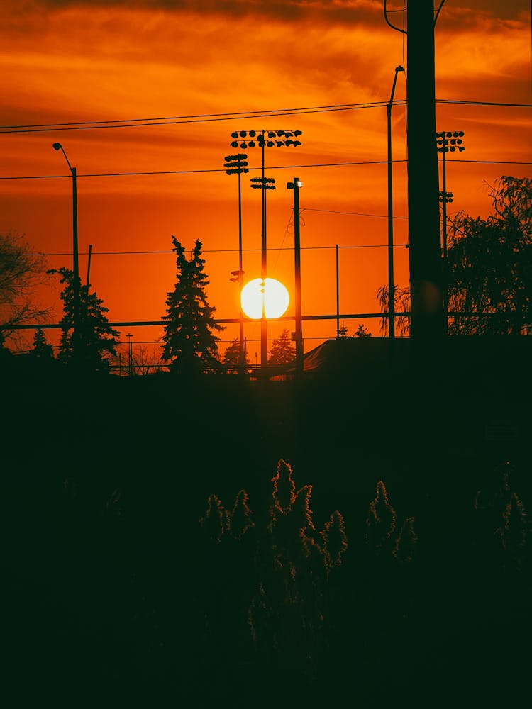 Sun On Yellow Sky Over Town At Sunset