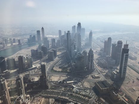 Stunning aerial view of Dubai's skyscrapers and modern architecture under a hazy sky.