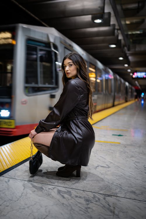 Woman Crouching on Metro Station