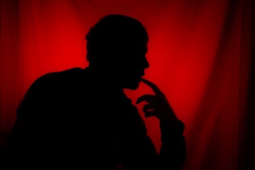 Silhouette of a Person on Red Background