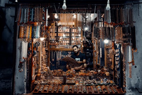 Man Sitting at Store with Jewelry
