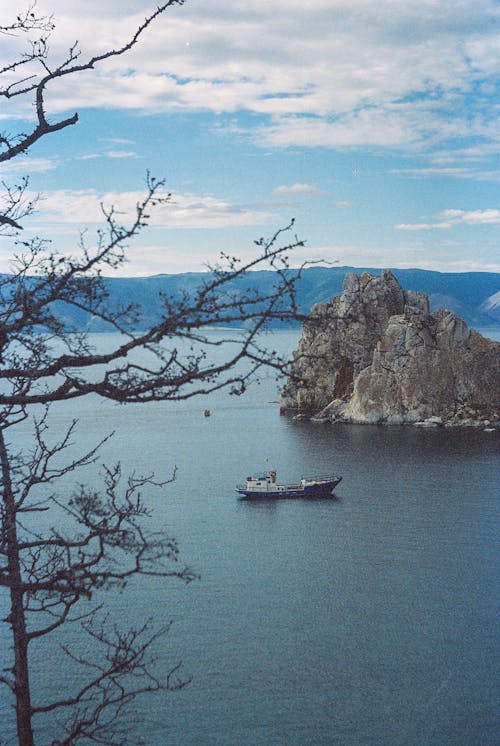 Boat Sailing Near Rock Formation