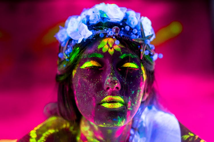 A Woman Face Glowing With Neon Paint