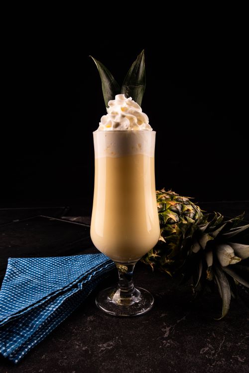 Free Delicious pineapple smoothie topped with whipped cream, perfect for a tropical refreshment. Stock Photo